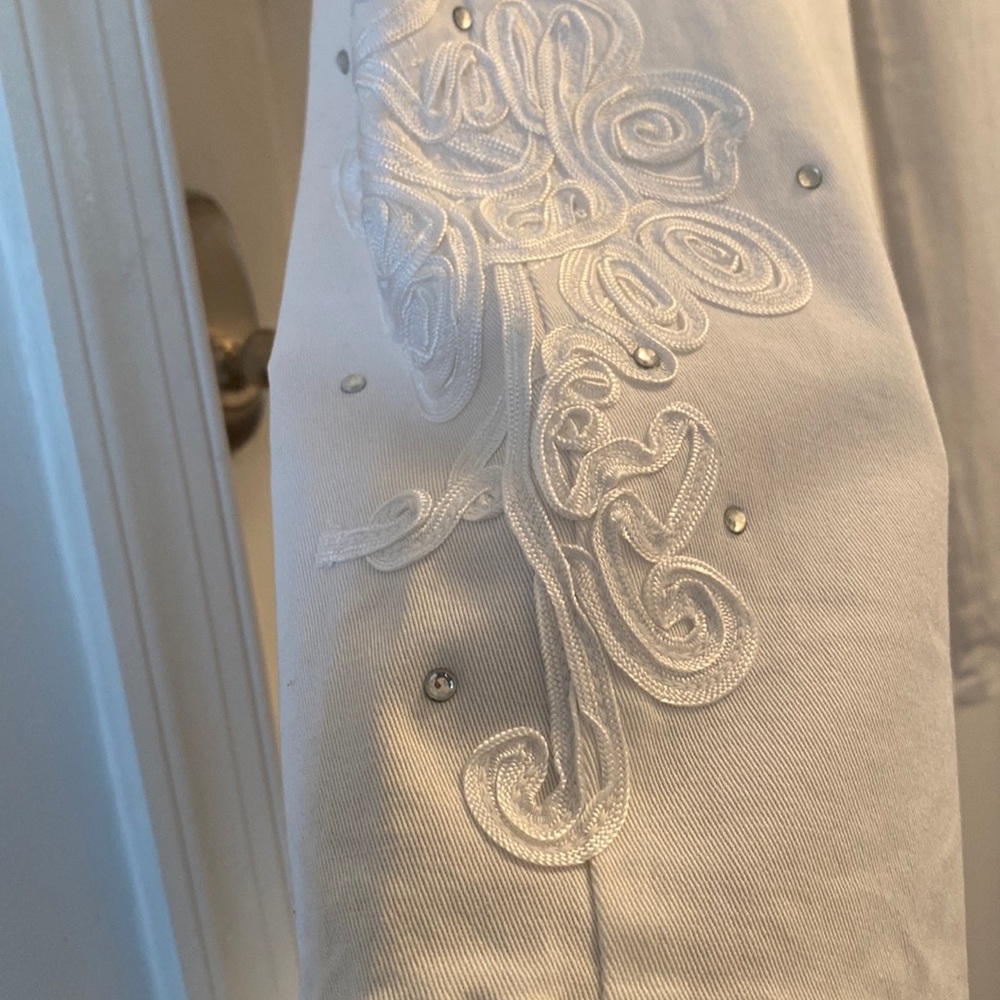 Size medium, color cream with beautiful  designs on the side.